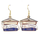 A pair of dangle earrings displayed on a white background. The earrings say Bibliophile in the middle of a stack of blue books.
